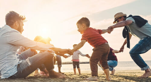 Family playing on beach 