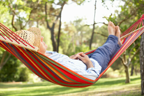 person laying in hammock 