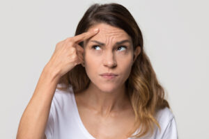 Woman pushing on forehead