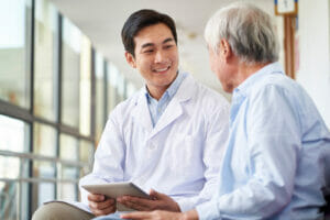 older man asking doctor questions