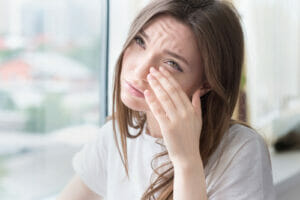 woman wiping eyelids 