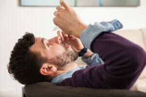 man using dry eye drops